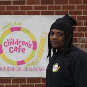 Person standing near Children's Cafe sign.